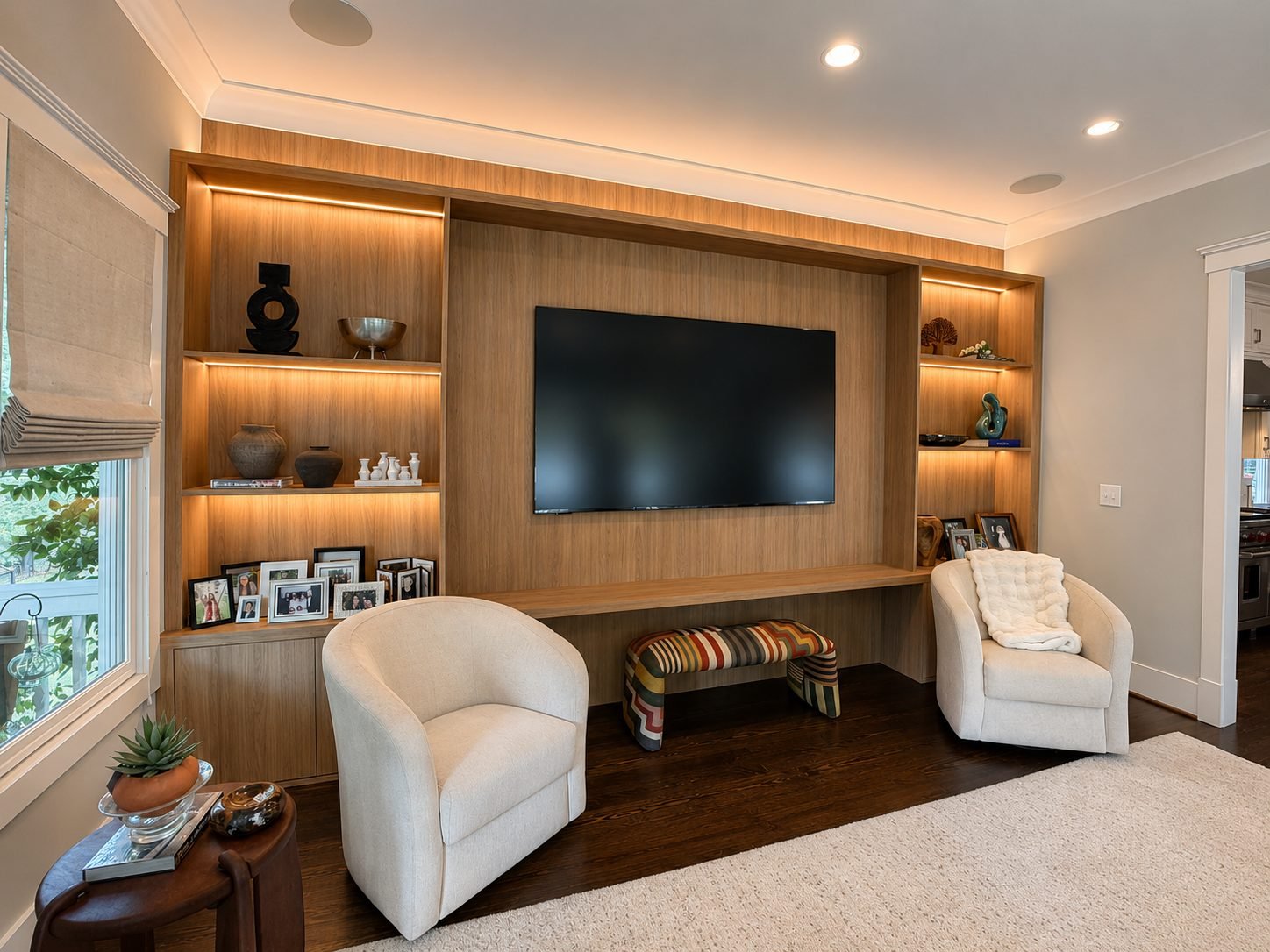 Living room media wall with wood paneling, backlit display niches and a wall-mounted television
